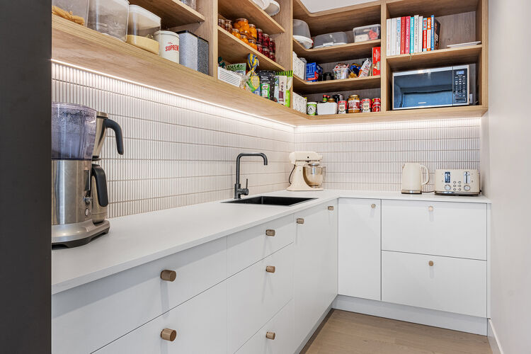 Modern compact kitchen with a tiled backsplash.