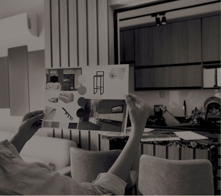The Wigglebum Moment Man and woman in a modern kitchen with dark cabinets and white countertops.